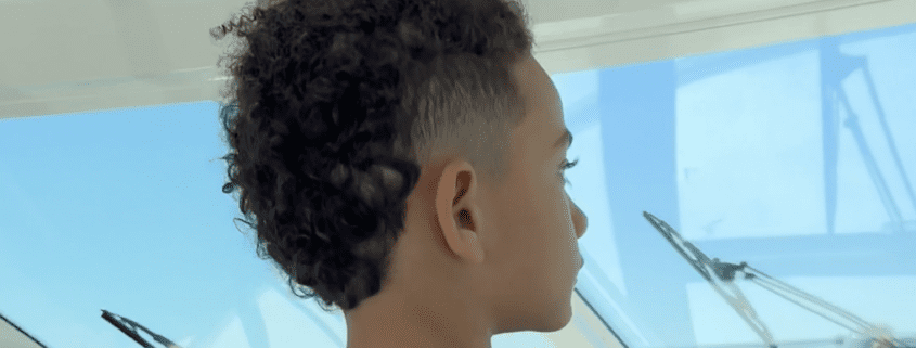 Child looking out boat window.